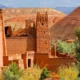 ### The Super South Morocco Holidays - Safari Tour 2025/2026 Embark on an extraordinary journey with the Super South Morocco Holidays - Safari Tour 2025/2026, a premier experience in Morocco tours. This exceptional tour itinerary from Marrakech offers a perfect blend of adventure, culture, and relaxation, making it one of the best Marrakech tour itineraries available. Designed for discerning travelers, this Morocco safari tour takes you through the heart of the country's most captivating landscapes and historical sites. Start your adventure with exhilarating Marrakech excursions, including a scenic drive through the High Atlas Mountains and visits to ancient kasbahs such as the UNESCO-listed Ait Benhaddou. As you travel deeper into the southern regions, explore the lush Draa Valley and its verdant palm groves on a unique bicycle tour. The journey continues to the stunning Sahara Desert, where you'll experience a memorable Marrakech desert tour. Ride camels across the majestic Erg Chebbi dunes in Merzouga, enjoy traditional Berber hospitality, and spend nights under the star-studded desert sky. Discover the vibrant culture of the Merzouga region, with opportunities for camel treks, ATV rides, sandboarding, and more. The Morocco desert tour also includes a visit to the dramatic Todra Gorge and the picturesque Dades Valley, where you can trek through scenic trails and enjoy a traditional Berber lunch. The adventure culminates with a drive through the beautiful Rose Valley and a visit to the film-making hub of Ouarzazate before returning to the vibrant city of Marrakech. The Super South Morocco Holidays - Safari Tour 2025/2026 offers an unparalleled experience, combining the best elements of Moroccan culture, history, and natural beauty. Whether you're seeking thrilling adventures, cultural immersion, or serene landscapes, this tour promises an unforgettable journey through the super south of Morocco.